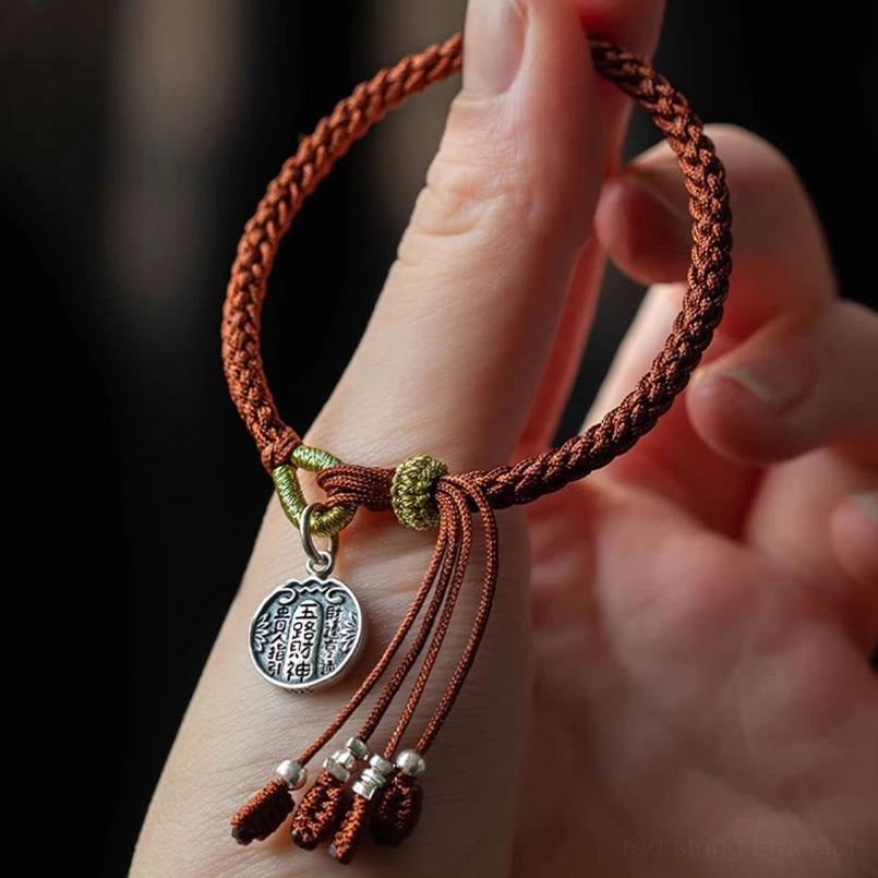 Hand displaying 925 silver five wealth gods red string bracelet on wrist