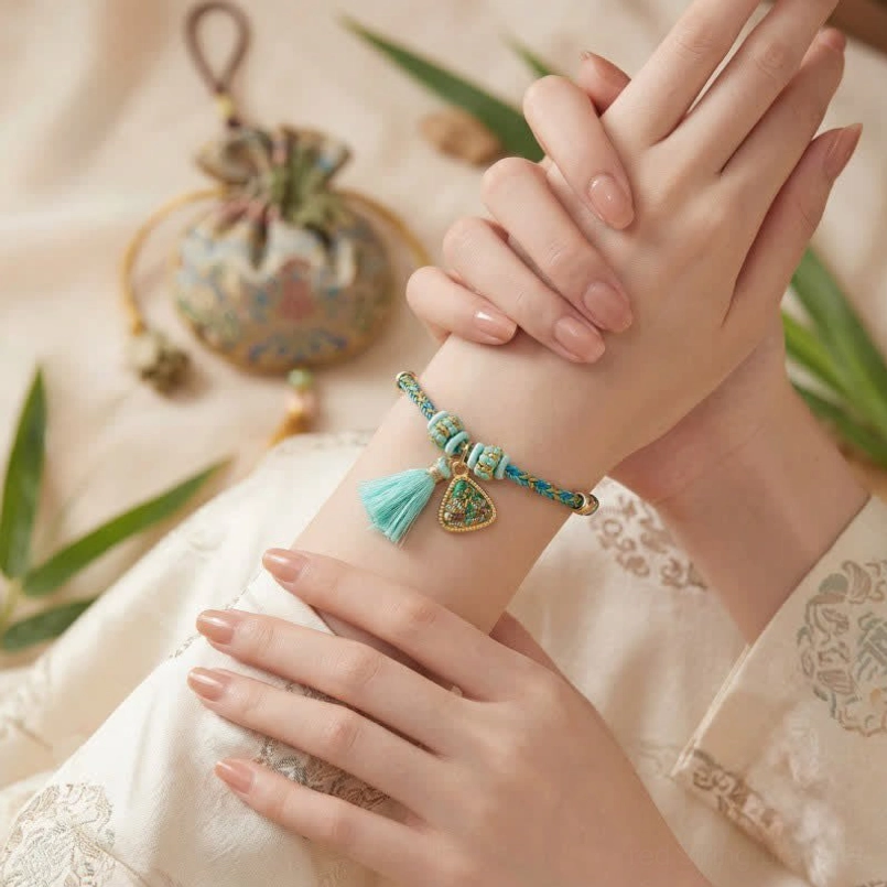 Wearable five-color Song Brocade charm bracelet close-up shot on wrist with traditional Hanfu clothing and decorative sachets