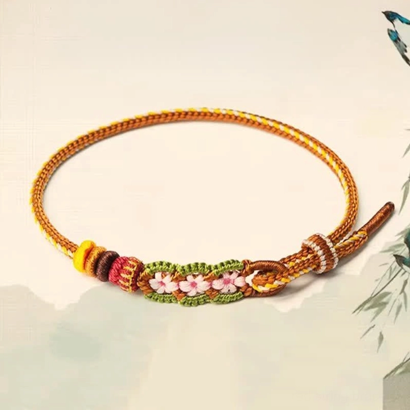 Chinese knotting fortune bracelet with decorative beads and sliding adjustable knot on watercolor painting background