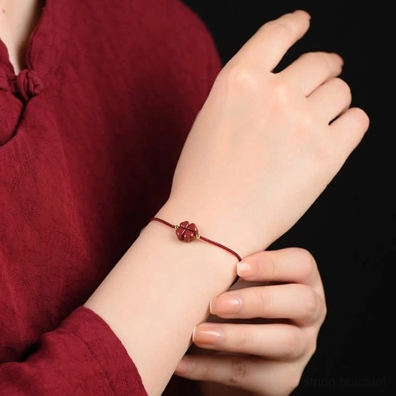 Handcrafted cinnabar four leaf clover red string bracelet artisan craftsmanship detail