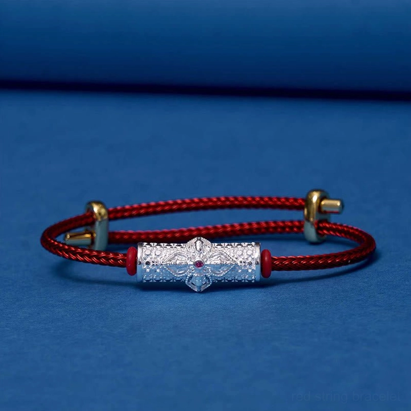 Handcrafted red string luck bracelet with ornate copper flower bead charm