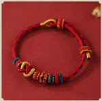 Handcrafted Red Peach Blossom Peace Knot Red String Bracelet Flat Lay View