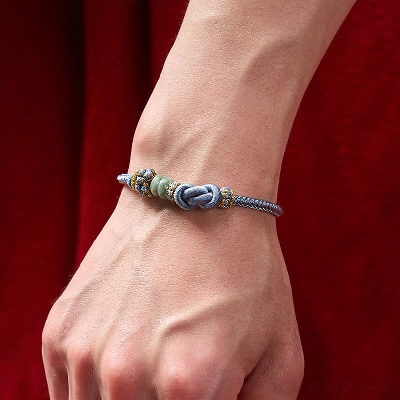 Handcrafted red string jade bracelet with artisanal knotwork design