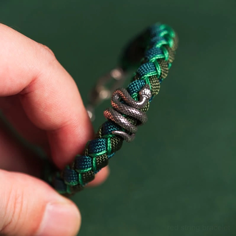Handheld Close Up of Detailed 999 Sterling Silver Snake Charm Bracelet