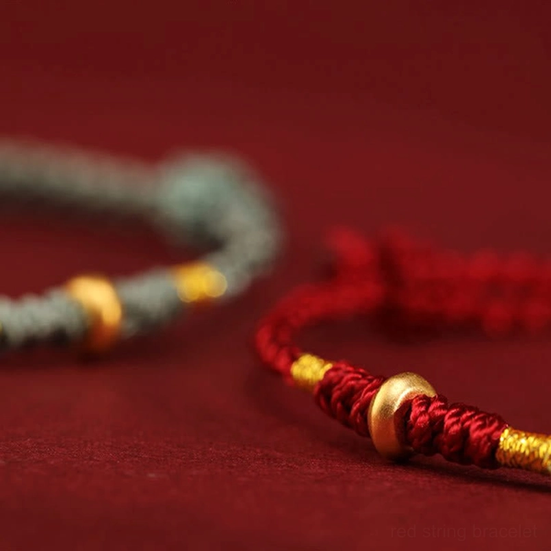 Handmade 999 gold lucky bead red string bracelet close-up detail shot