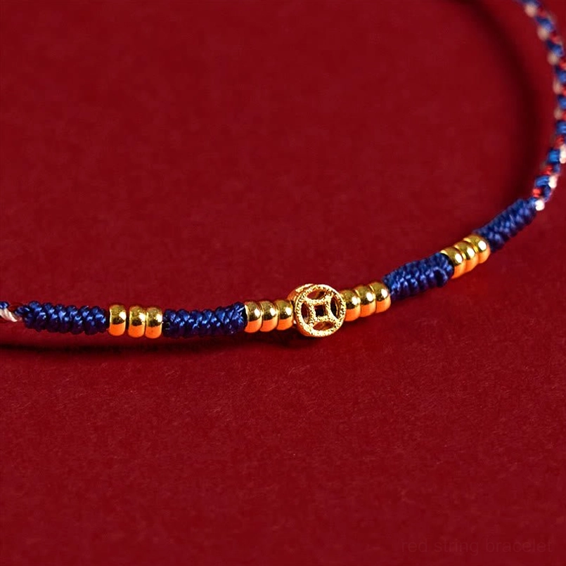 Handmade red string copper coins luck bracelet detail shot showing knots and metal beads