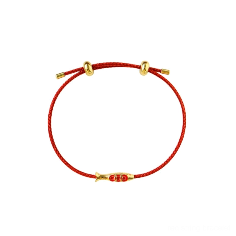 Koi fish red string wealth bracelet flat lay on plain white background