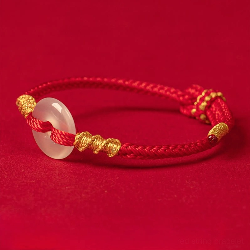 Handmade white chalcedony red string bracelet with golden decorative end caps and twisted knots