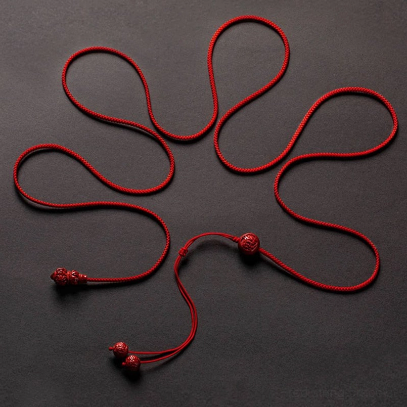Handmade cinnabar zodiac belly chain showing artisanal craftsmanship and natural variations