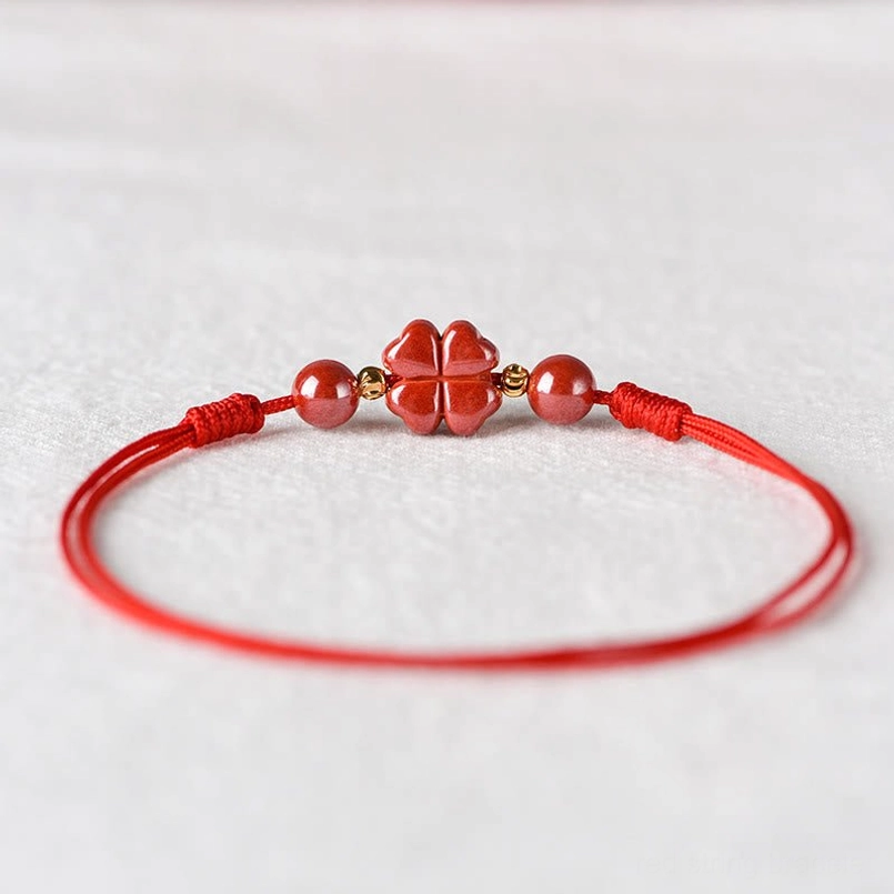 Hand-knotted red string bracelet with cinnabar four-leaf clover charm natural materials