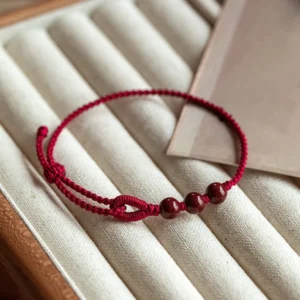 Handmade dark red braided cinnabar bead blessing bracelet top view