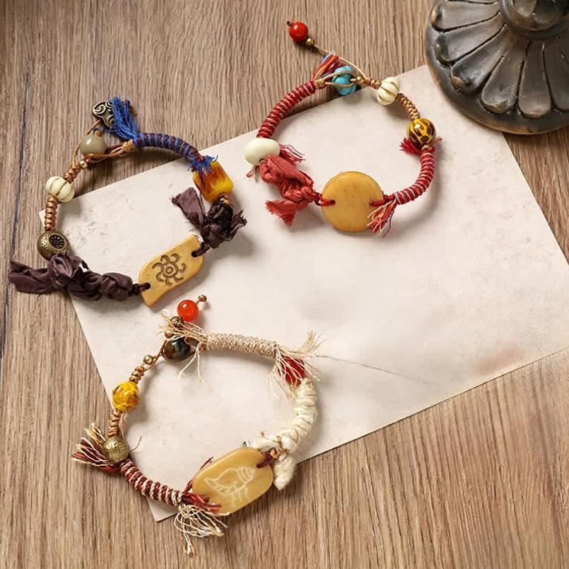 Artisan handmade bracelets with mixed rope colors and carved Fu charm collection