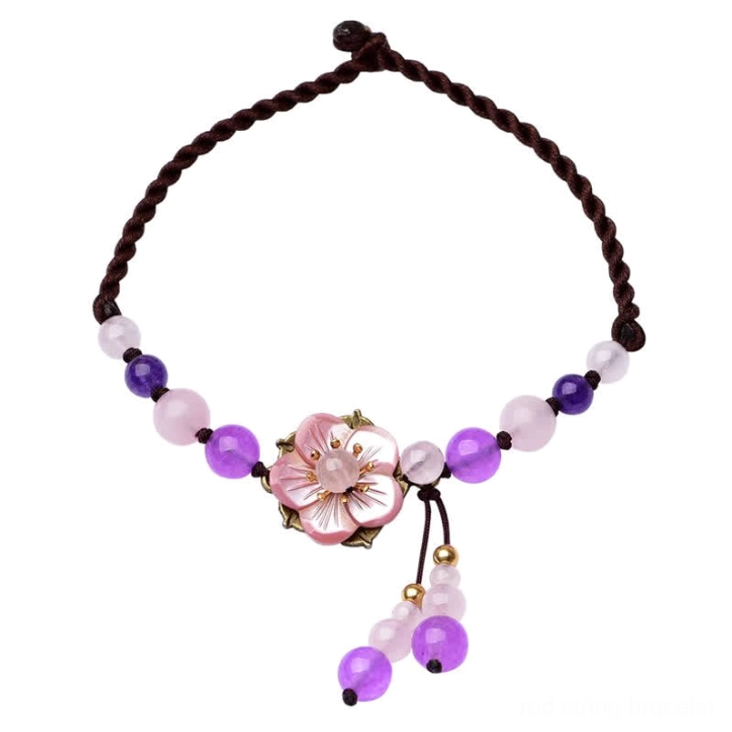Flat lay of adjustable amethyst and rose quartz healing anklet with braided natural fiber cord