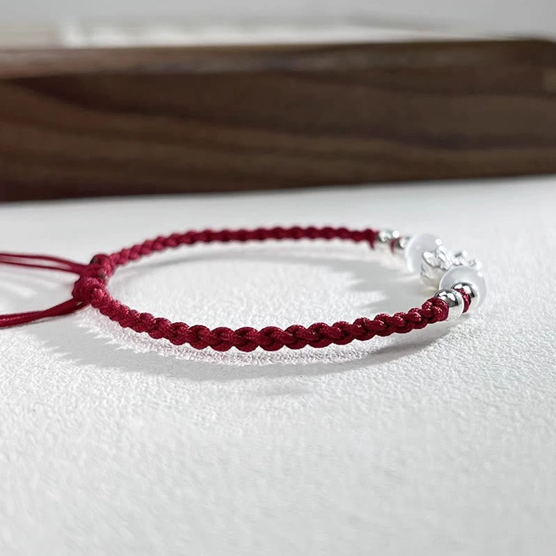 gift packaging shot of handmade lotus red string bracelet with gift box