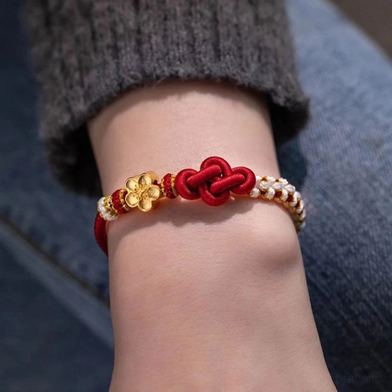 Adjustable red string bracelet with true love knot worn on wrist showing side profile and casual styling