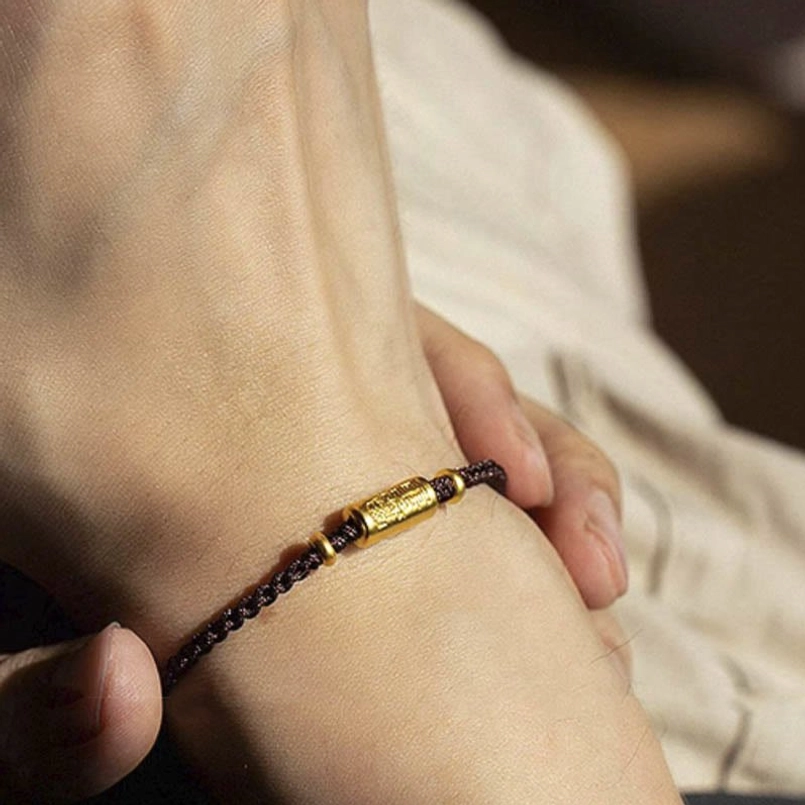 Red string bracelet with gold engraved amulet - handmade craftsmanship