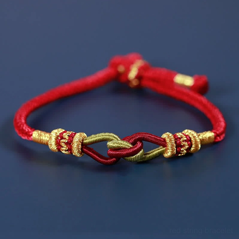 Handmade braided red string bracelet with gold woven knots flat view