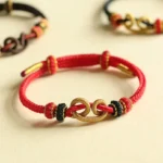 Handmade Red String Ingot Pattern Braided Protection Bracelet Flat Lay