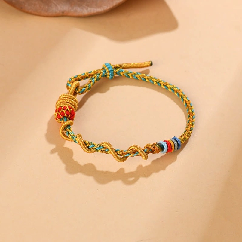 Handmade red string luck bracelet with twisted braided rope and gold bead accents