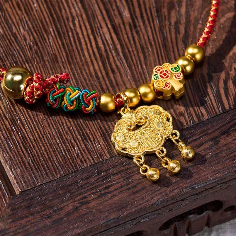 Close-up detail of handmade red string pet collar with colorful braids and gold tassel lock