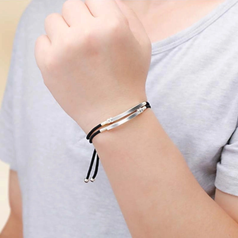 Handcrafted red cord bracelet with natural materials and artisanal sterling silver details