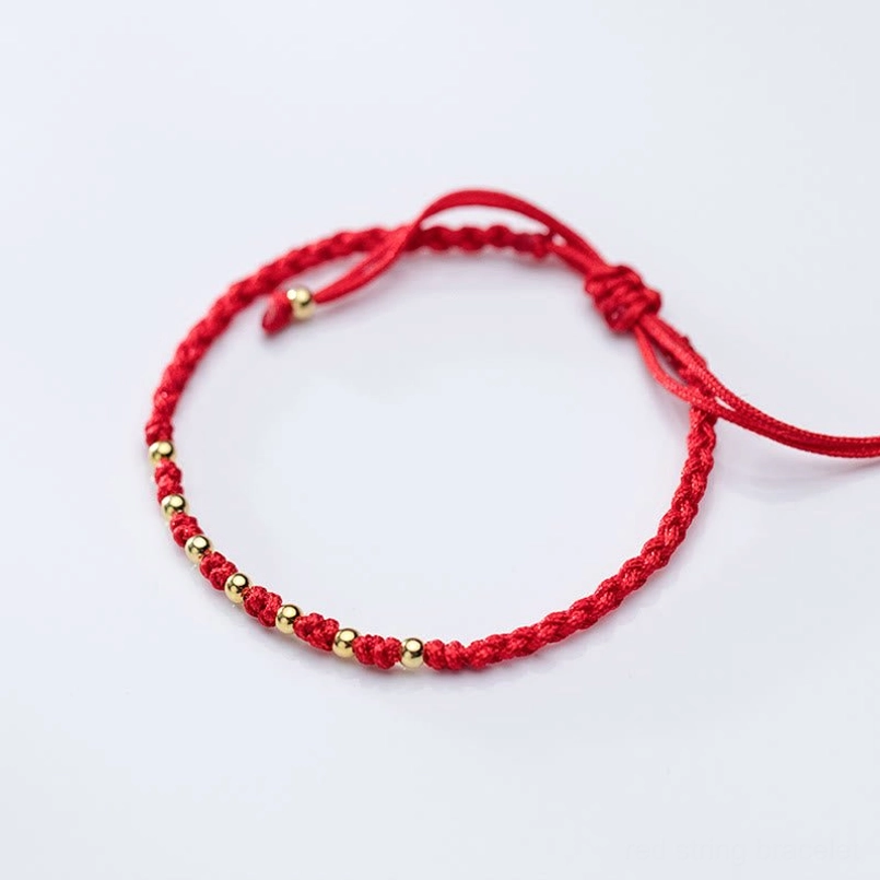 Handcrafted red cord bracelet with sterling silver gold plated beads close view