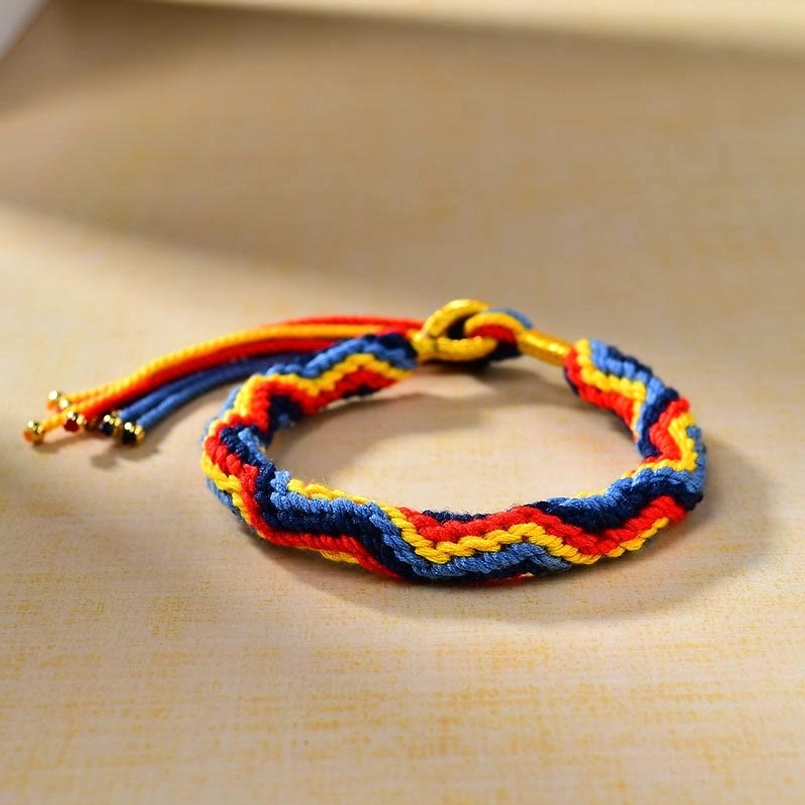 Tibetan colored rope bracelet with gold metal hardware oblique view