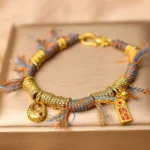 Top flat view of handmade Tibetan multicolor lucky braided string bracelet on velvet jewelry tray