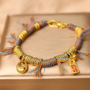 Top flat view of handmade Tibetan multicolor lucky braided string bracelet on velvet jewelry tray