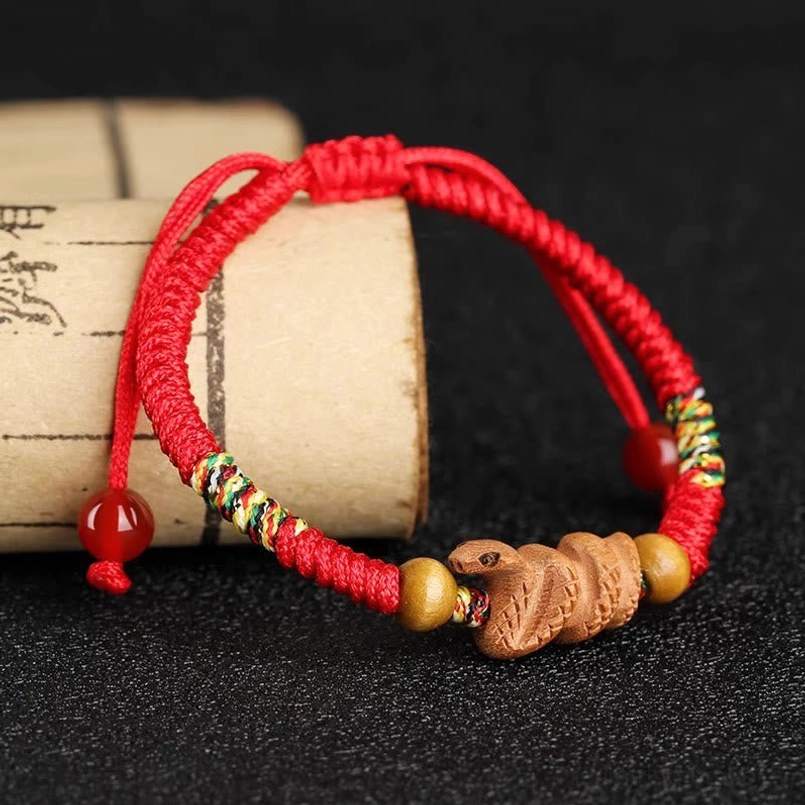 Handmade zodiac red string bracelet flat lay composition