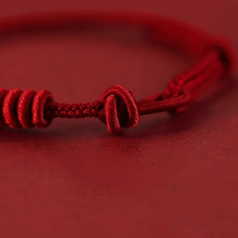 Detailed braided rope texture of eight stranded red string bracelet