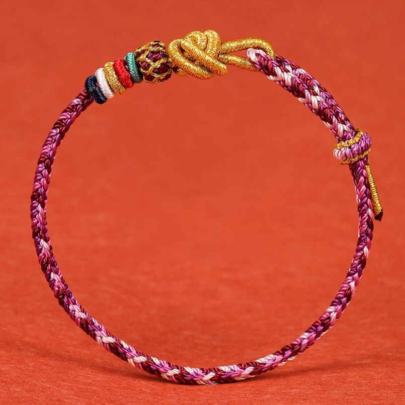 Maroon braided handcrafted string bracelet with adjustable golden knot closure