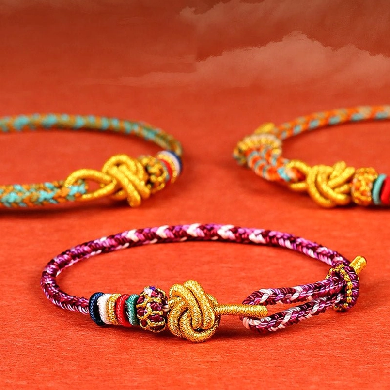 Multiple handcrafted protection bracelets in vibrant colors arranged to show variety