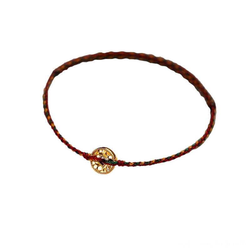 Handwoven brown-red string bracelet with single gold copper coin charm on white background