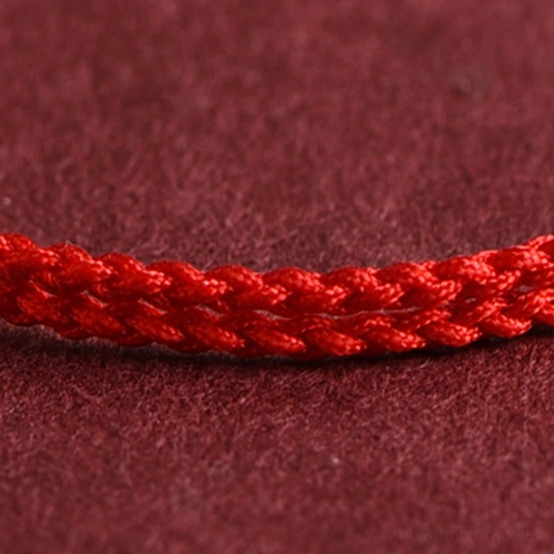 Braided red rope texture close up of handmade luck red string bracelet