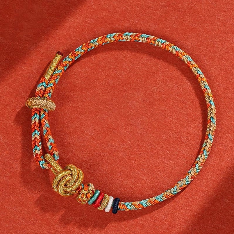 Single handcrafted braided string bracelet with orange and blue tones and golden knot