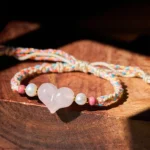 Heart Shaped Pink Crystal Braided Red String Bracelet Side Overhead View