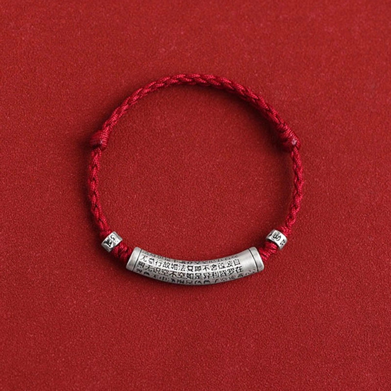 999 sterling silver Buddhist mantra bracelet flat lay alternative angle on red background