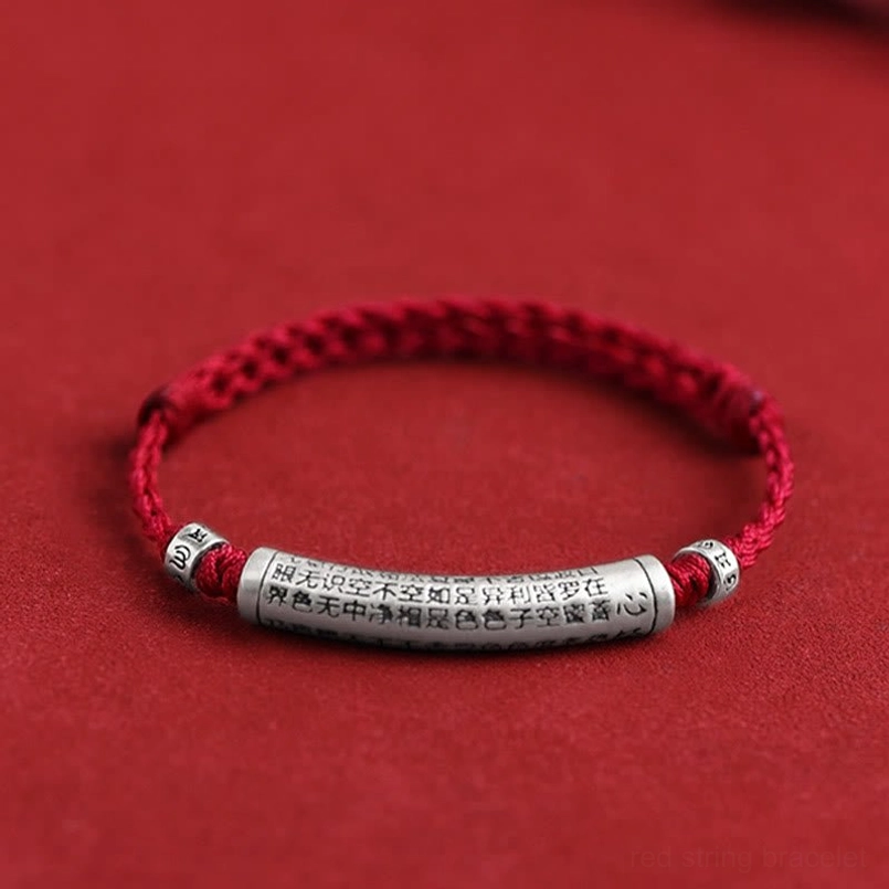 Handmade 999 sterling silver Heart Sutra Om Mani Padme Hum bracelet with dark red woven rope on red background