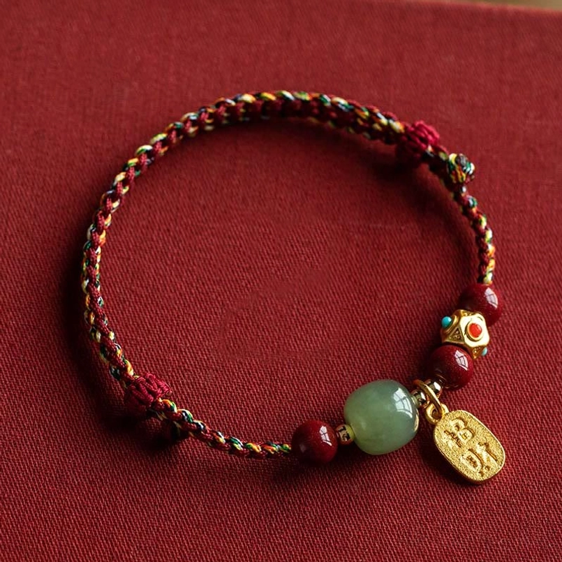 Cyan jade prosperity bracelet with five-colored braided string and gold charm pendant detail
