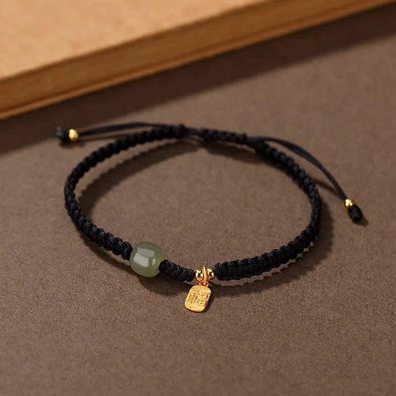 Black woven Hetian jade fortune bracelet with adjustable cord and gold charm