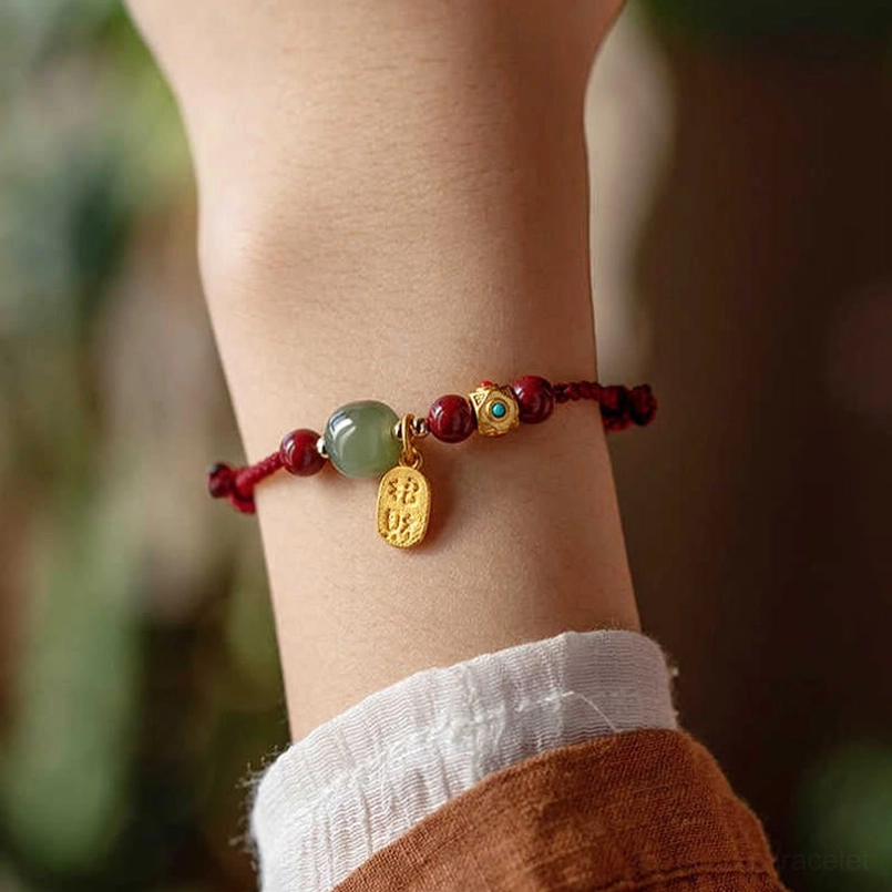 Five-colored blessed string prosperity bracelet worn on white linen sleeve, demonstrating daily wearability