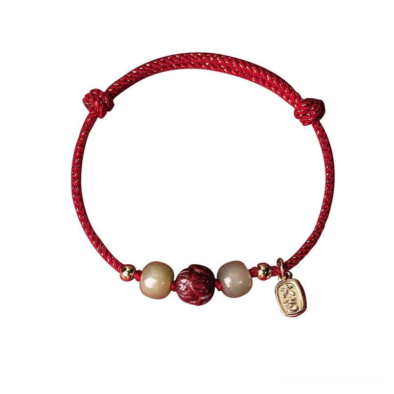 Complete red cord Hetian jade cinnabar lotus lucky bracelet - front view with gold accent