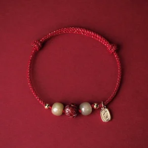 Red string Hetian jade cinnabar lotus lucky bracelet with 14K gold plating - top view flat lay