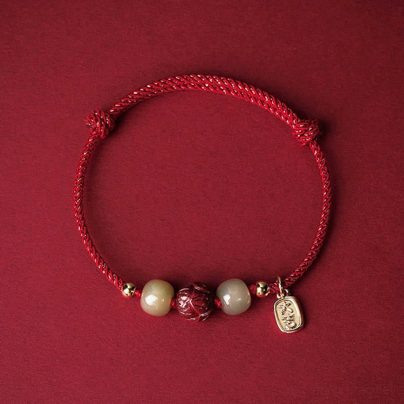 Red string Hetian jade cinnabar lotus lucky bracelet with 14K gold plating - top view flat lay