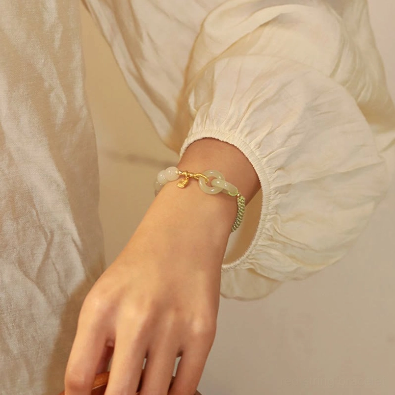 Hetian jade double peace buckle fu character abundance bracelet product lifestyle shot indoor natural lighting