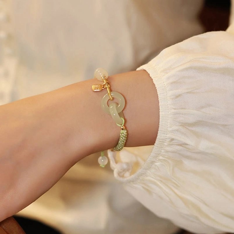 Hetian jade fu character pendant with gold plating on double peace buckle abundance bracelet macro detail