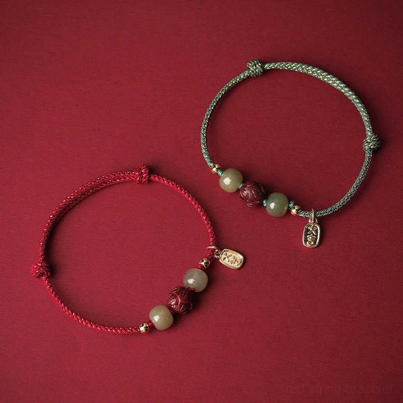 Two mixed color red string lucky bracelets with matching jade and cinnabar beads - flat lay comparison
