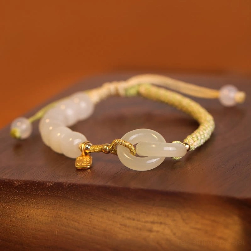 Hetian jade double peace buckle fu bracelet showing natural color variation in pale milky jade stones
