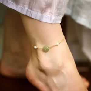 Hetian jade peace buckle pearl anklet worn on ankle with gold chain and white pearls